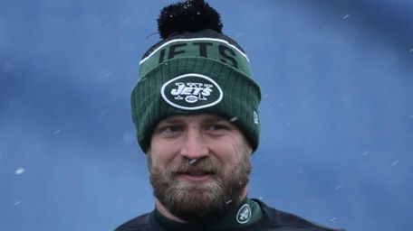 Ryan Fitzpatrick of the New York Jets warms