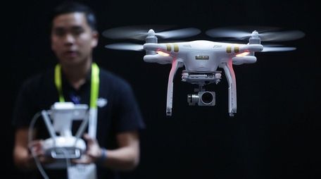 A DJI employee demonstrates flying a drone at