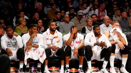The Brooklyn Nets' bench looks on late in