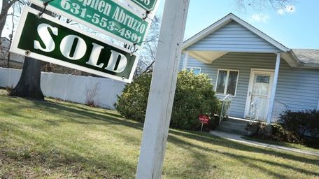 A "sold" sign is posted outside the home