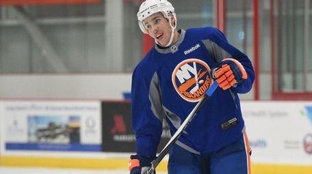 New York Islanders defenseman Travis Hamonic looks on