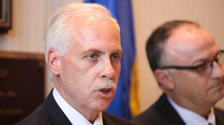 Suffolk County Legis. Kevin McCaffrey speaks beside Legis.