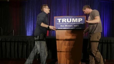 Workers takes the podium down after Republican presidential