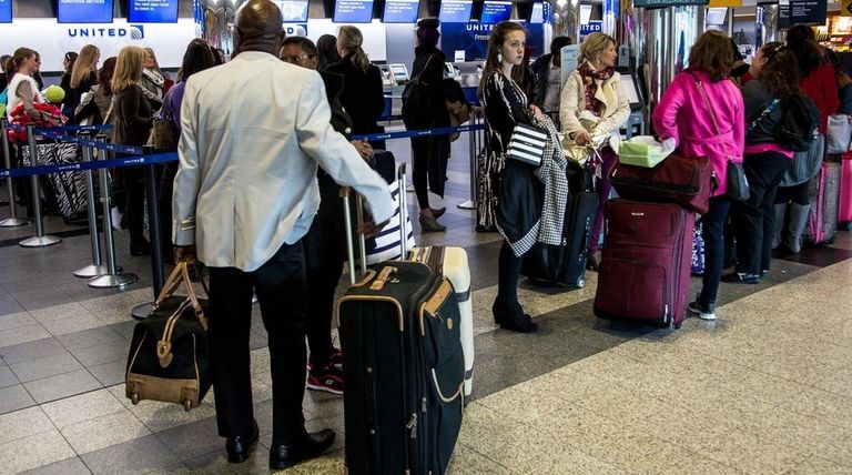 Holiday travelers wait at LaGuardia Airport on Nov.