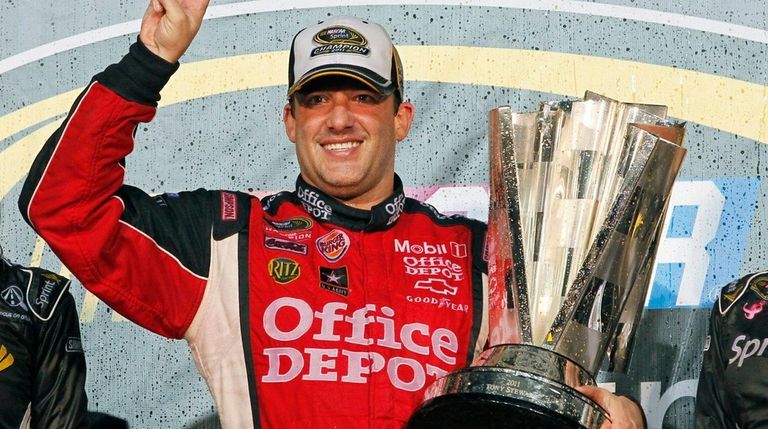 Tony Stewart celebrates after winning his third