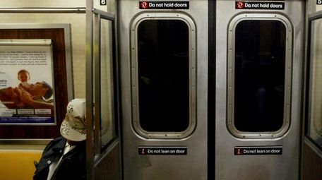 A New York City subway rider dozes on
