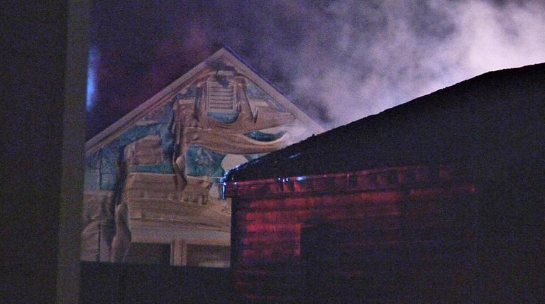 Smoke rises from a fire in a garage
