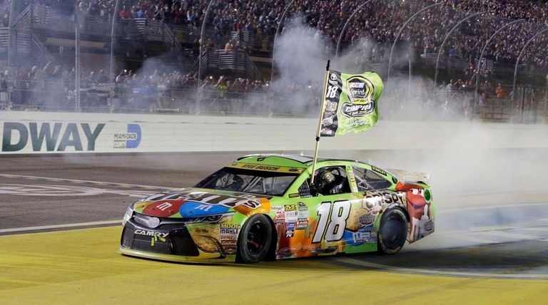 Kyle Busch celebrates after winning the NASCAR