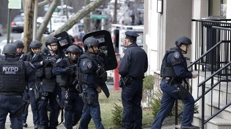 New York City police enter a hotel, Wednesday,