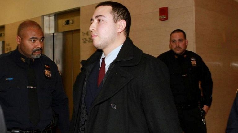 Officer Shaun Landau leaves the courtroom during Officer