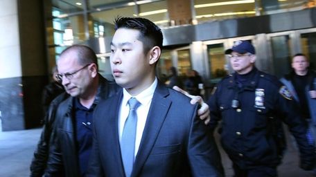 NYPD Officer Peter Liang is escorted out of