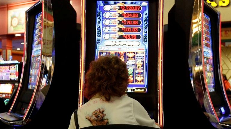A woman plays a video lottery terminal Oct.