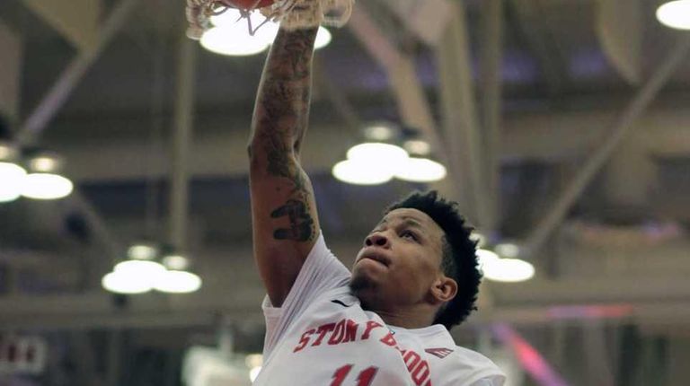 Rayshaun McGrew dunks the ball during Stony Brook's
