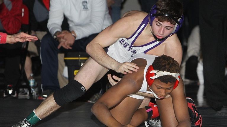Port Jefferson's Matteo DeVincenzo wrestles Lajess Sawyer of