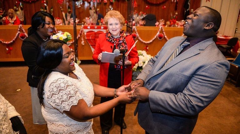 Delin and Henjy Jean-Baptist, of Huntington, laugh while