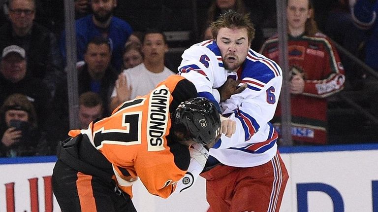 New York Rangers defenseman Dylan McIlrath fights with