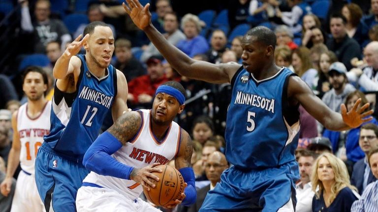 New York Knicks' Carmelo Anthony, center, is double-teamed