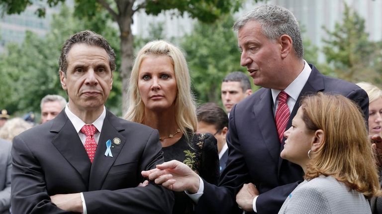 Gov. Andrew Cuomo, left, listens to New York