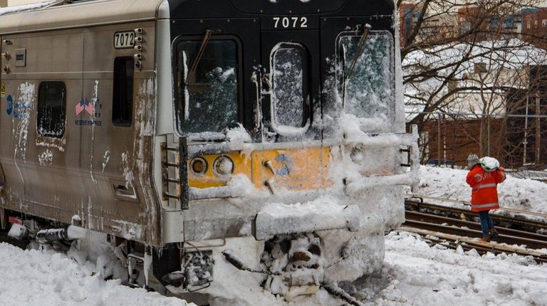An LIRR worker walks the tracks at Jamaica