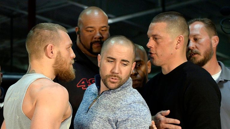 UFC featherweight champion Conor McGregor (L) and