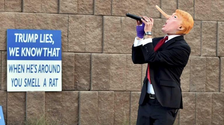 Gil Mobley wears a Donald Trump costume while