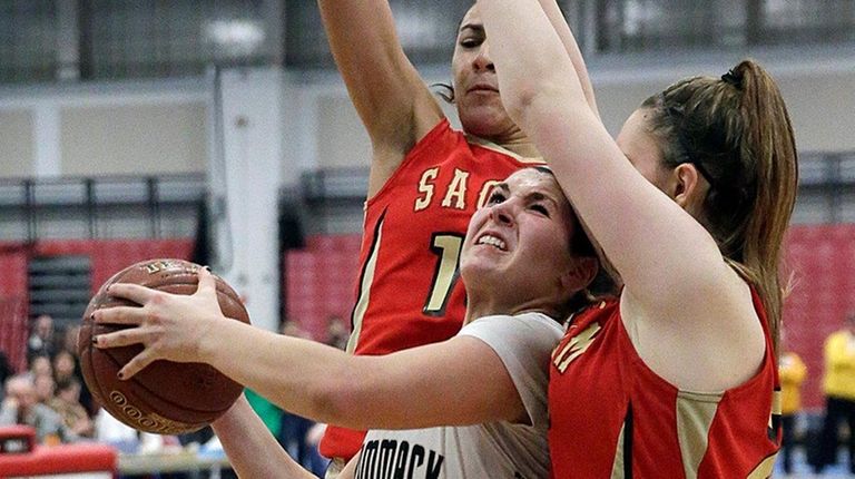 Commack guard Jackie DelliSanti drives between Sachem East's