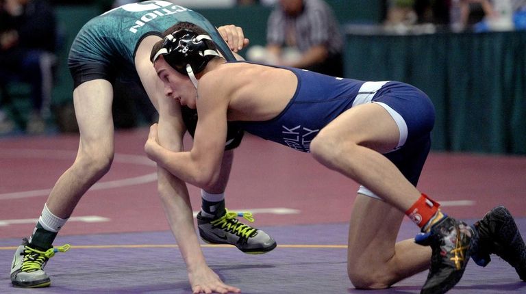 Deer Park's Tommy Cox, right, wrestles against Farmingdale's