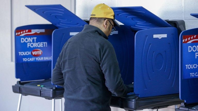 A man casts his ballot in the