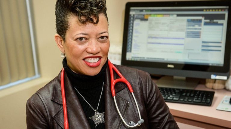 Dr. Michele C. Reed sits near her computer