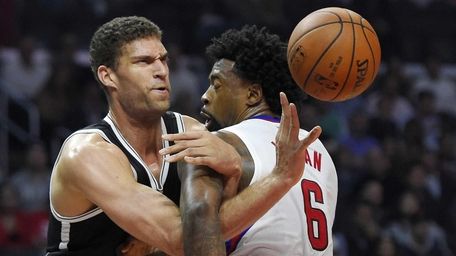 Brooklyn Nets center Brook Lopez, left, tangles with