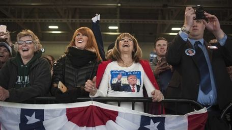 Attendees smile as Donald Trump, the 2016 Republican