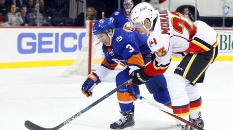 Travis Hamonic of the New York Islanders defends