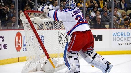 New York Rangers goalie Henrik Lundqvist pushes over