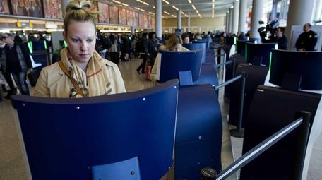 Traveler Liza Leach of Boston uses an automated