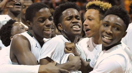 Elmont teammates celebrate after their 41-32 win
