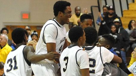 Baldwin teammates celebrate after their 65-55 win over