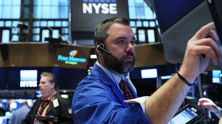 Traders work on the floor of the