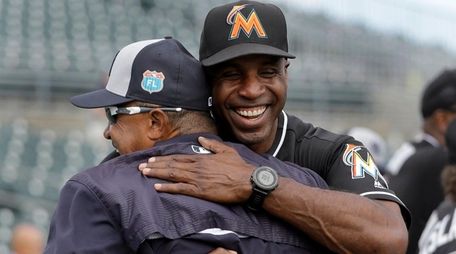 Marlins hitting coach Barry Bonds, right, greets Yankees
