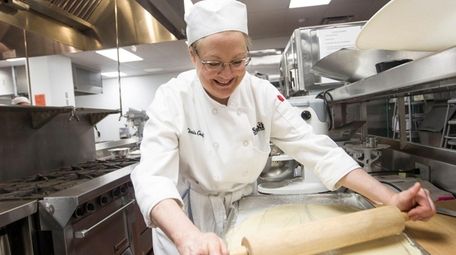 Christine Graf rolls out the sweet dough in