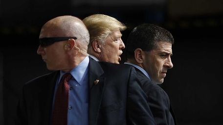 Secret Service agents surround Republican presidential candidate Donald