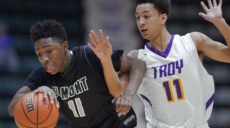 Elmont's Travis Robinson-Morgan shields the ball from Troy's
