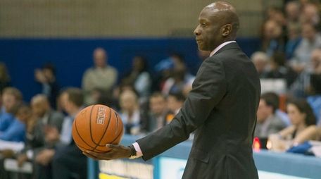 Yale men's basketball coach James Jones holds the