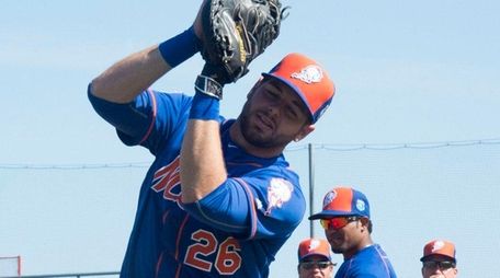 Mets catcher Kevin Plawecki works on catching