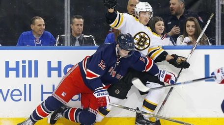 Brad Marchand #63 of the Boston Bruins collides