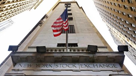 The American flag flies above the Wall Street