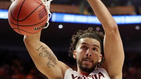 Anthony Gill #13 of the Virginia Cavaliers dunks