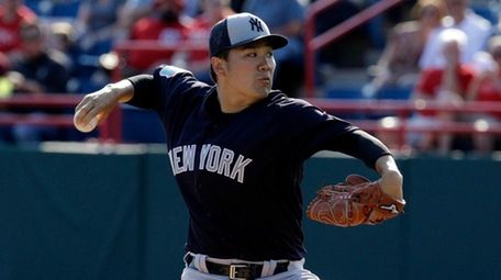 The Yankees' Masahiro Tanaka pitches against the Washington