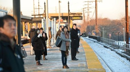 Passengers wait for a delayed Manhattan-bound train at