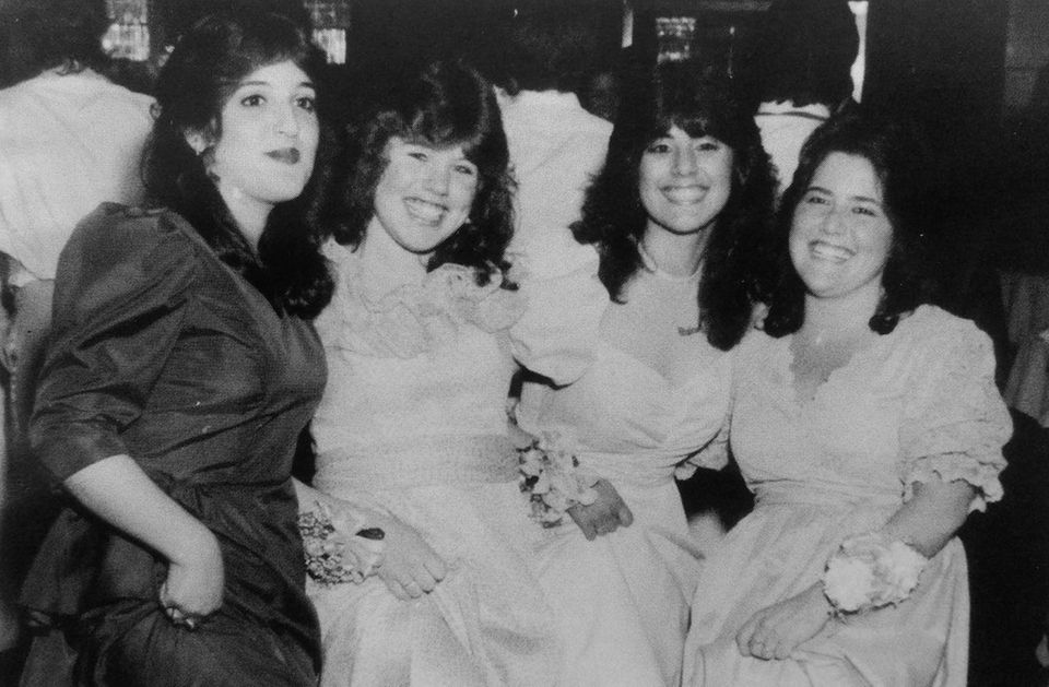 A quartet of students smile for the camera