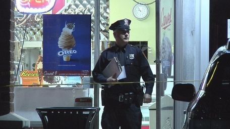 A Suffolk police officer stands outside a Commack